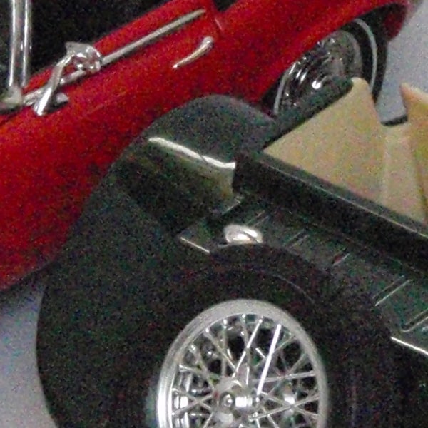 Close-up of toy cars with noticeable pixelation.Close-up of miniature model cars on display.