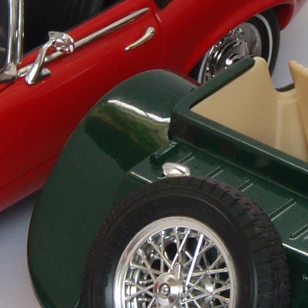 Close-up of vintage red and green model carsClose-up of vintage toy cars, red and green, with chrome details.