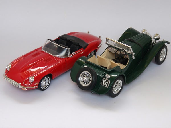 Model cars: Red Jaguar E-Type and Green Classic Convertible.Two model cars, a red convertible and a green classic car.