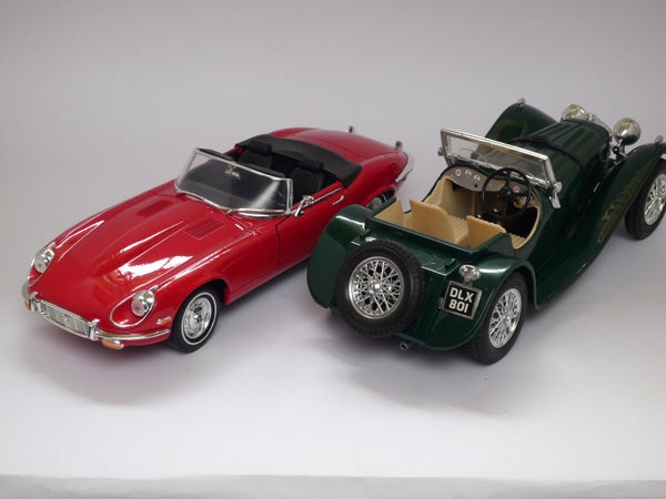 Two model cars displayed on a white backgroundTwo model toy cars on a white background.