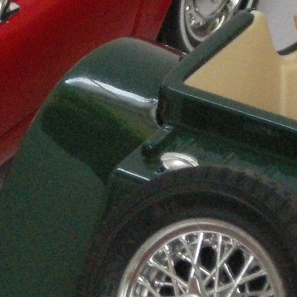 Close-up of a classic car's wheel and fenderClose-up of a green car's wheel and fender.
