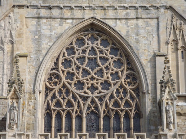 Gothic cathedral window architecture detail photograph.Gothic cathedral window with intricate stone tracery.