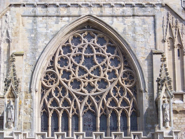 Detailed Gothic window architecture with stone traceryGothic church window with stone tracery and stained glass