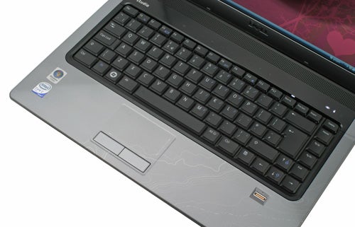 Dell Studio 15 laptop showing keyboard and touchpad.Dell Studio 15 notebook keyboard and touchpad close-up.