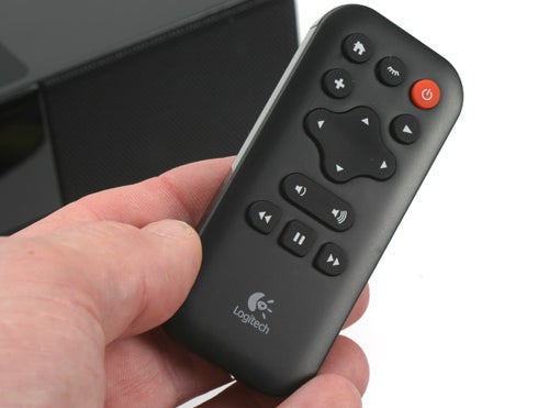 Hand holding Logitech Squeezebox Boom remote control.