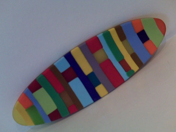 Colorful abstract pattern on a surfboard-shaped object.