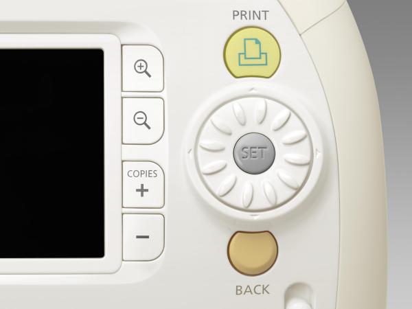 Close-up of Canon Selphy ES3 printer's control panel.