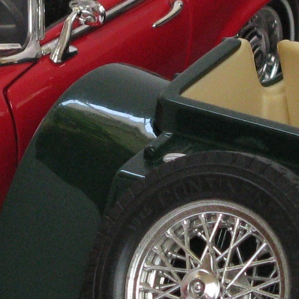 Close-up of a classic car model wheel and fender.
