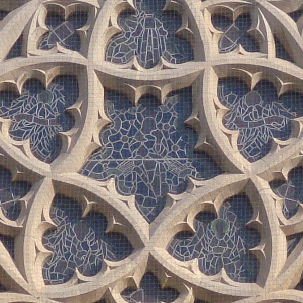 Stone window tracery with intricate Gothic design patterns.