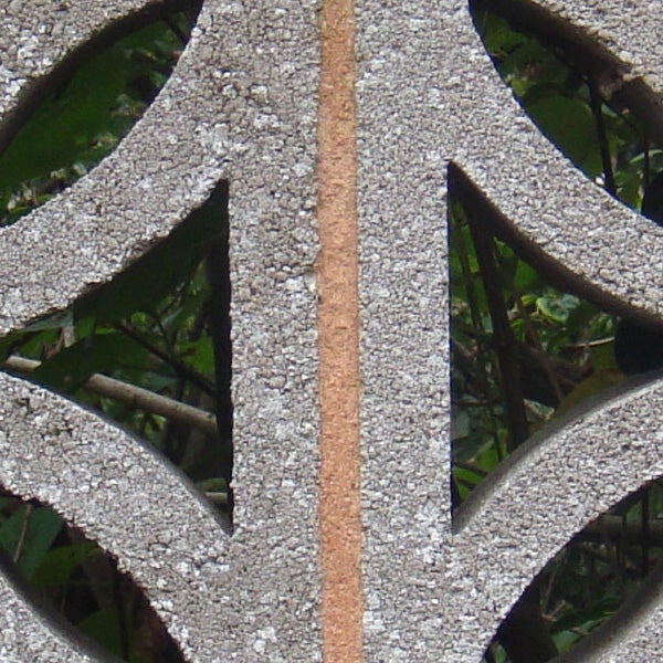 Close-up of a patterned metallic surface with a slender rust streak