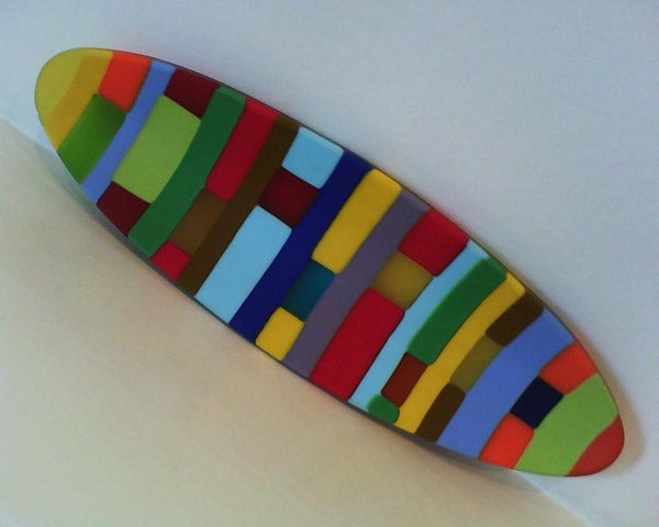 Colorful abstract art skateboard deck on white background.