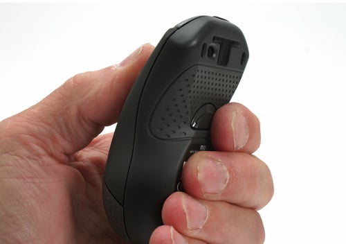 Hand holding a Gyration Air Mouse with MotionSense technology.