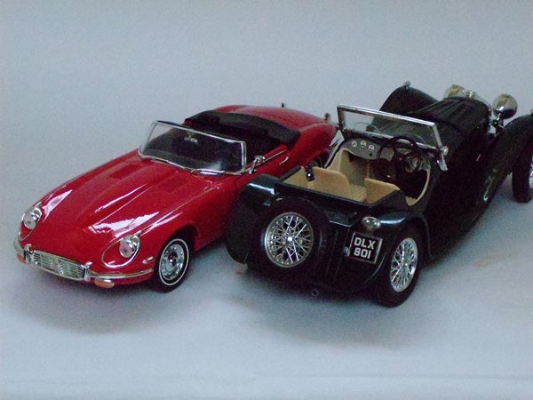 Red and black vintage toy cars on display.