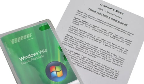 Windows Vista software package next to printed product review notes.