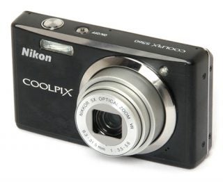 Nikon CoolPix S560 digital camera on white background.