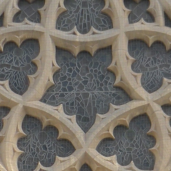 Close-up of intricate stone tracery on a building facade.