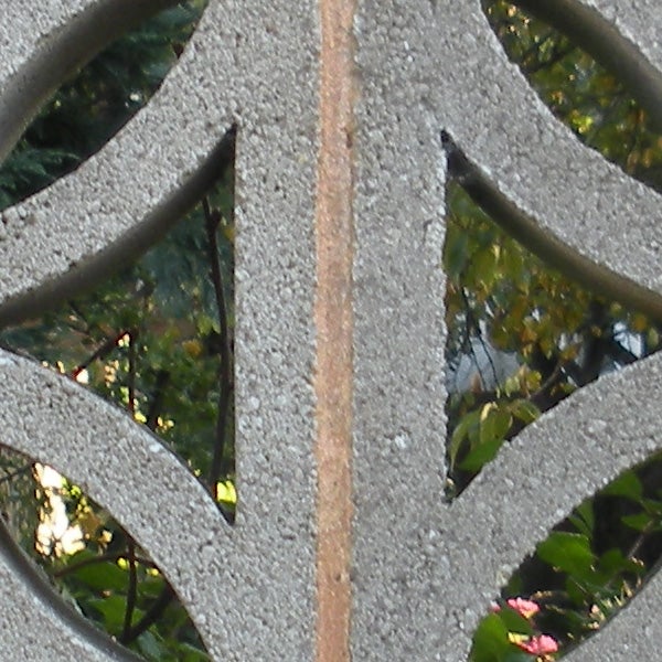 Concrete structure close-up with trees in background.