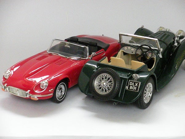Photo of two toy model cars on display.