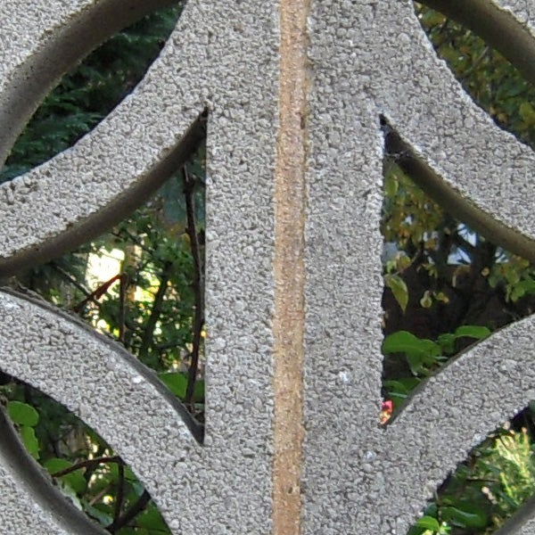 Detailed close-up of a textured metallic garden bench.