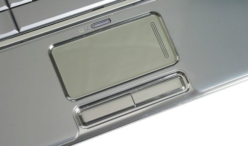 Close-up of HP Pavilion dv7-1000ea touchpad and multimedia buttons.