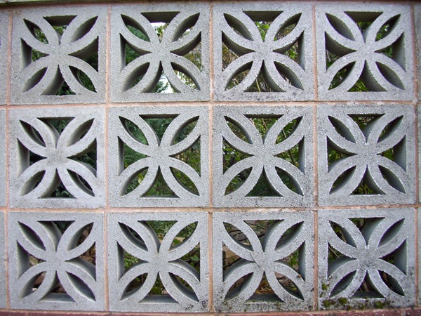 Decorative concrete block wall with symmetrical patterns.