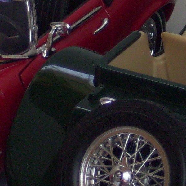 Close-up of vintage car wheel and parts.