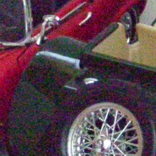 image of a classic car wheel and headlamp.