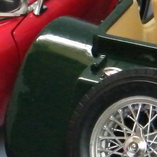Close-up of vintage car with detailed wheel design.