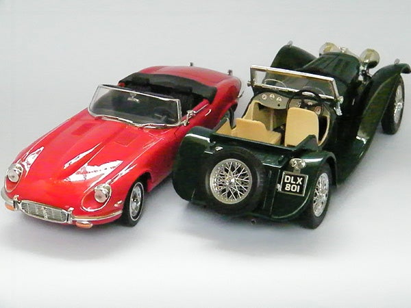 Photo of two model cars, red and green, taken with Fujifilm camera.