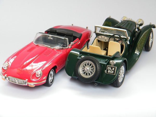 Two model cars, red and green, displayed against white background.