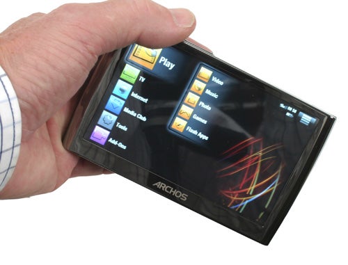 Hand holding an Archos 5 60GB media player.