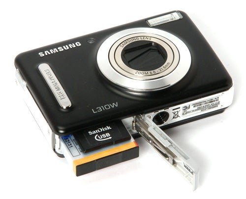 Samsung L310W digital camera with open battery compartment.