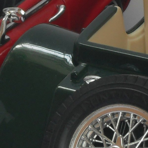 Close-up of a vintage car's tire and fender.