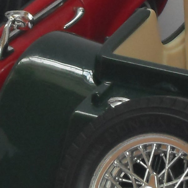 Close-up of a classic car wheel and fender.
