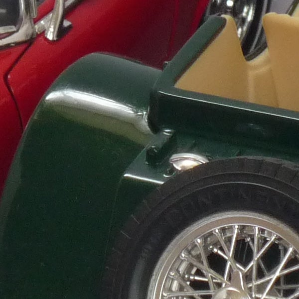 Close-up of classic car fender and wheel.
