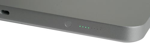 Close-up of MacBook 2008 side with battery indicator lights.