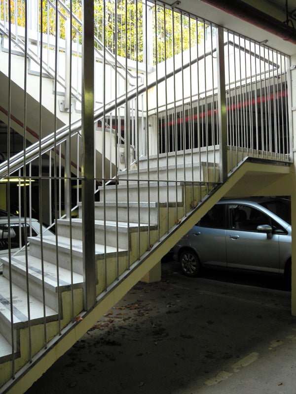 Staircase and car in a parking garage setting