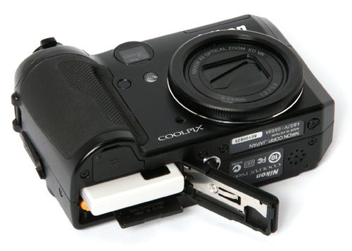 Nikon CoolPix P6000 camera with open battery compartment.