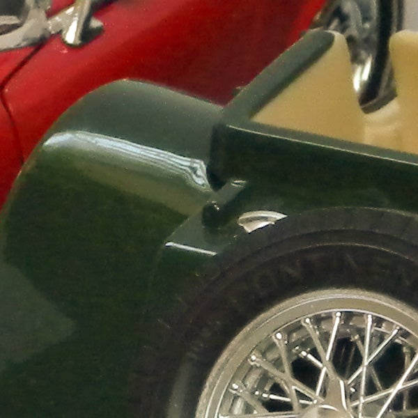 Close-up of vintage car's rear wheel and fender.