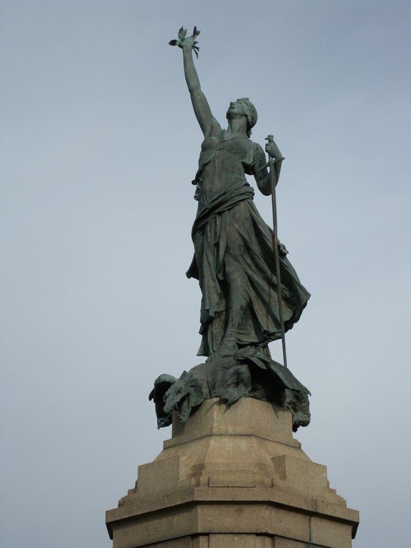 Statue against a clear sky with overcast conditions.