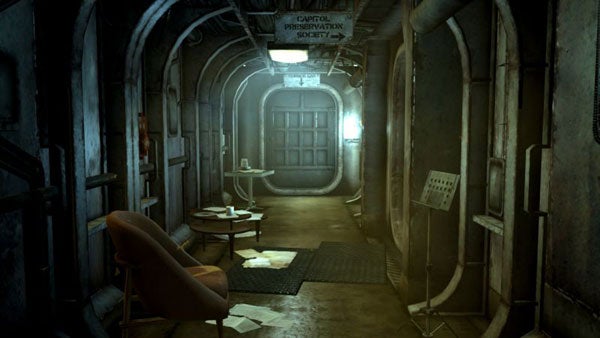 Interior of a Fallout 3 game vault corridor with chair and table.