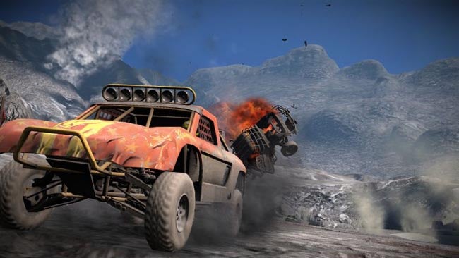 Off-road vehicles racing with one catching fire in MotorStorm Pacific Rift.