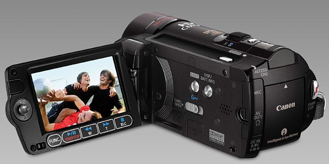 Canon HF11 camcorder with flip-out LCD screen displaying video.