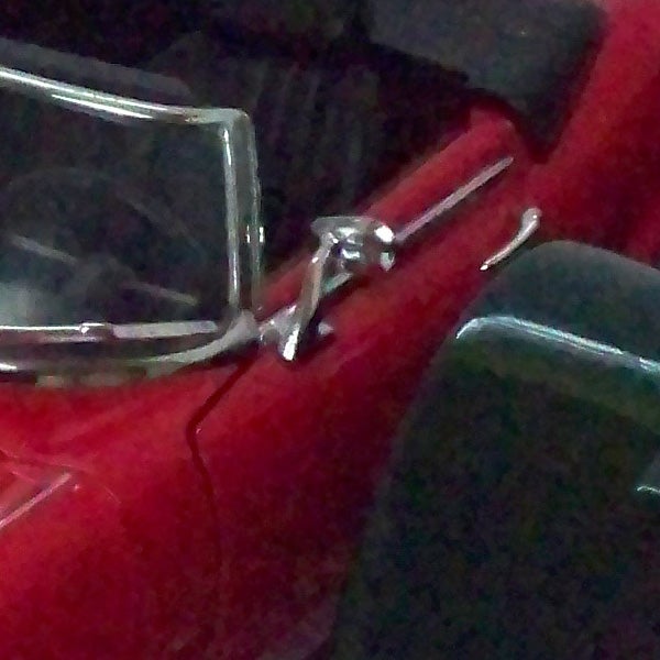 Grainy low-light shot of a red car by Kodak EasyShare M1093 IS.