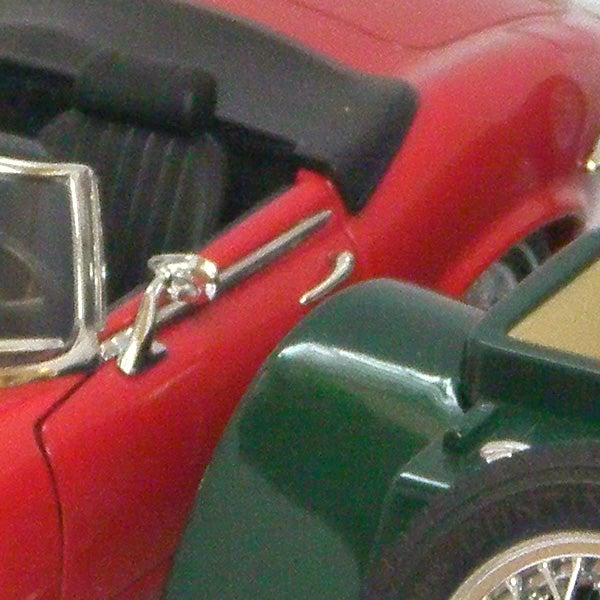 Close-up of a red and green toy car.