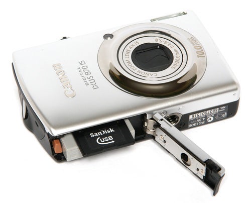 Canon IXUS 870 IS camera with open battery compartment.