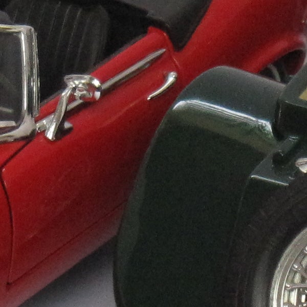 Close-up of a miniature red classic car model.
