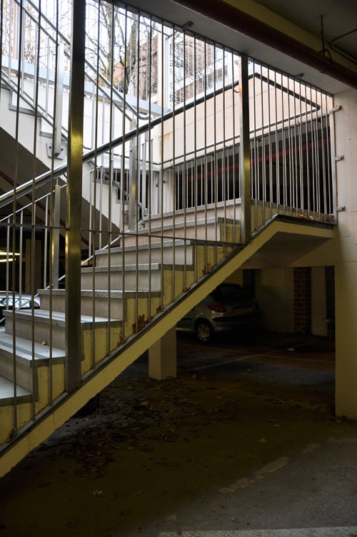 Photo taken with Nikon D90 showing indoor parking and staircase.