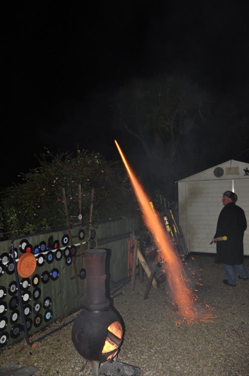 Nikon D90 captures a nighttime fire-spitting stove.