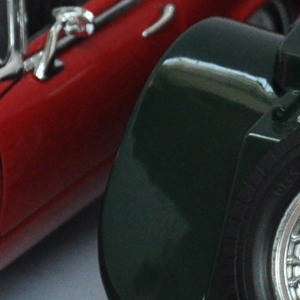 Close-up of a classic red toy car wheel.